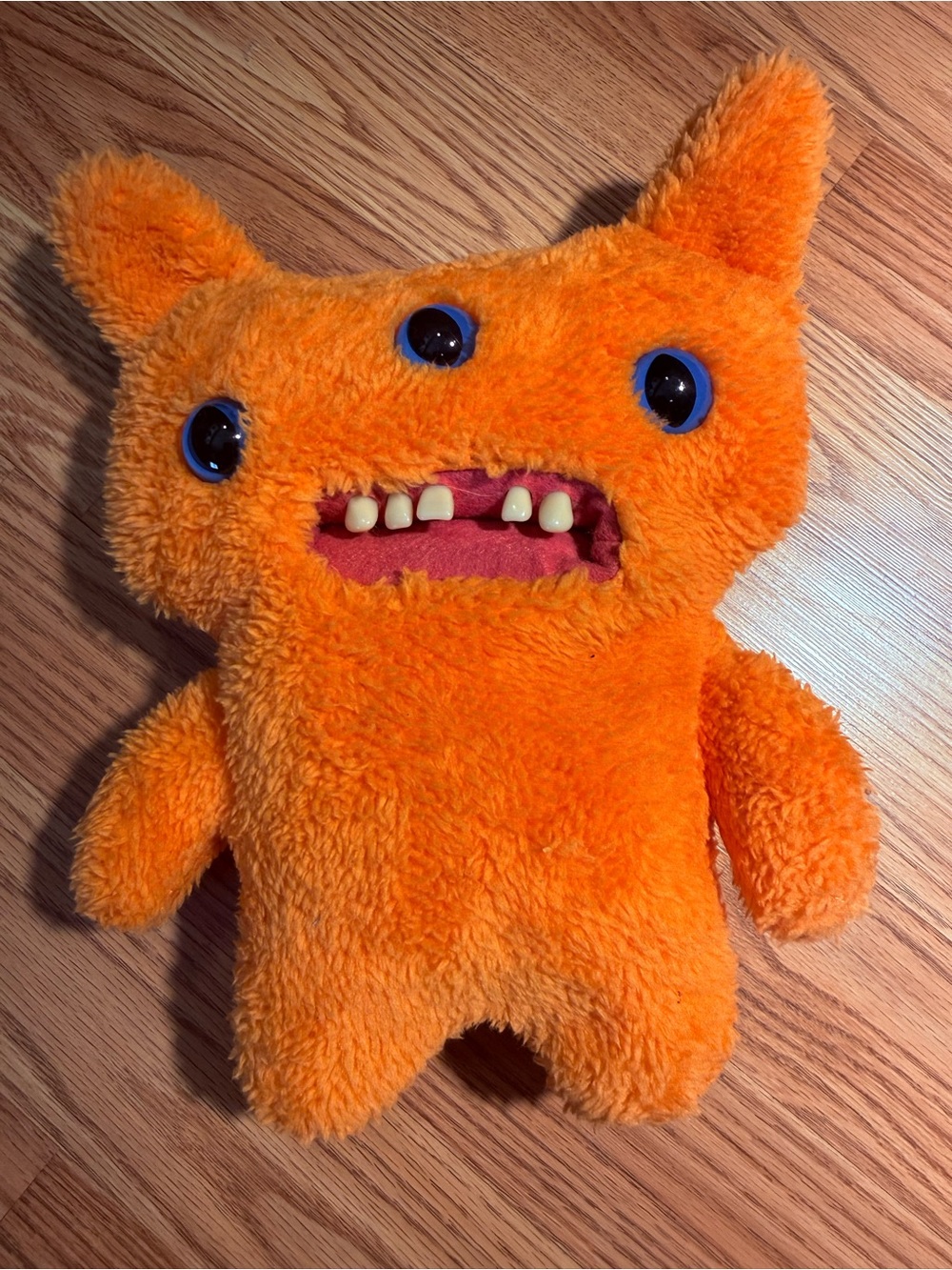 An orange Reek-O character from the Fuggler"Funny Ugly Monster"plush collection
